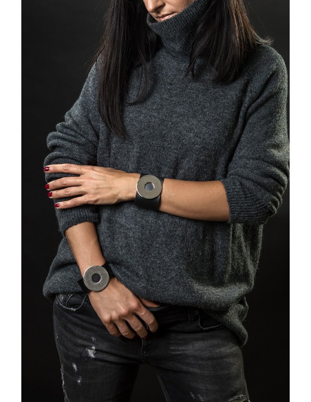 Wide black leather bracelet with matte steel circle and bold minimalist design