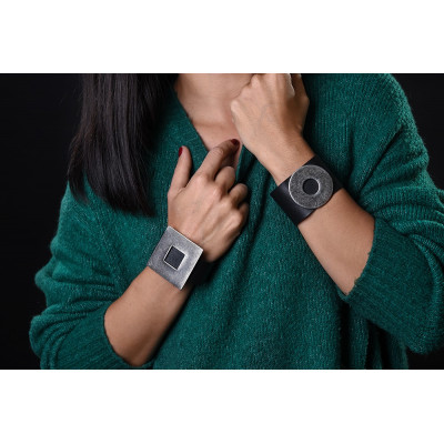 Wide black leather bracelet with matte steel circle and bold minimalist design 2