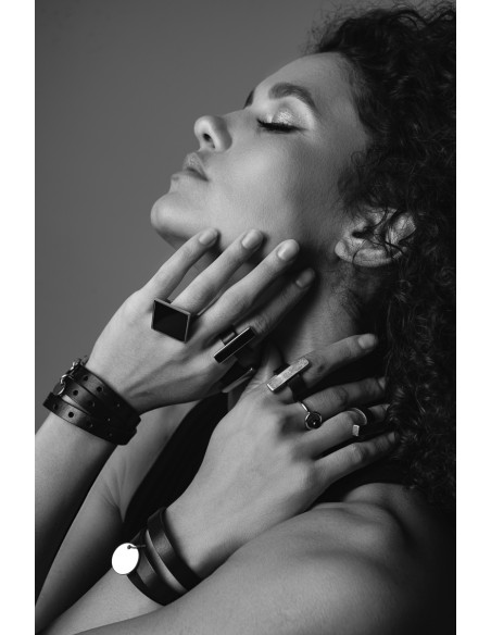 Black leather bracelet with decorative charms and gold clasp