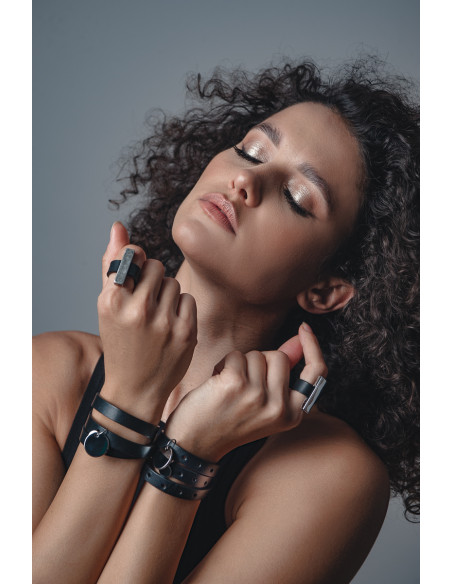 Black leather bracelet with decorative charms and gold clasp