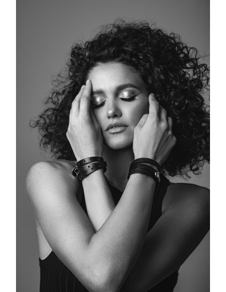 Triple-wrap black leather bracelet with gold-tone steel element and adjustable clasp