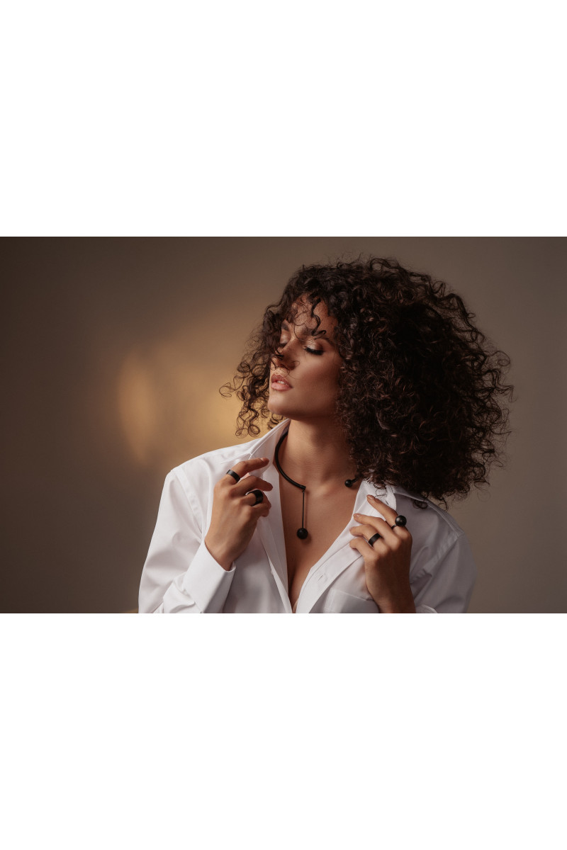 Black matte stainless steel necklace with decorative sphere.