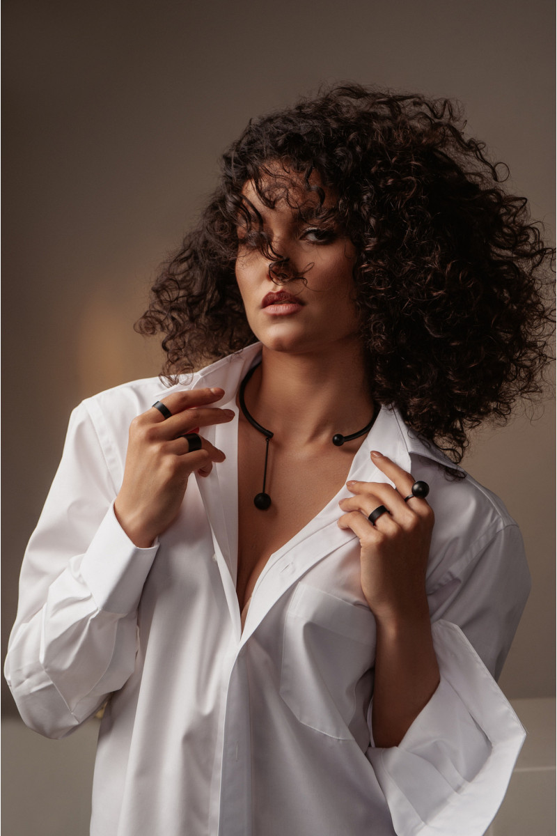 Black matte stainless steel necklace with decorative sphere.