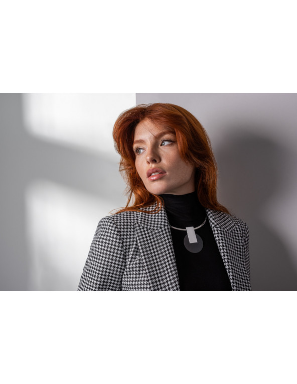 Stainless steel choker necklace with a decorative black and silver pendant