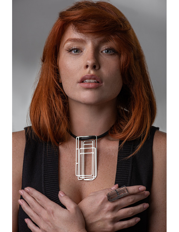 Delicate leather necklace with a shiny stainless steel pendant in a modern design