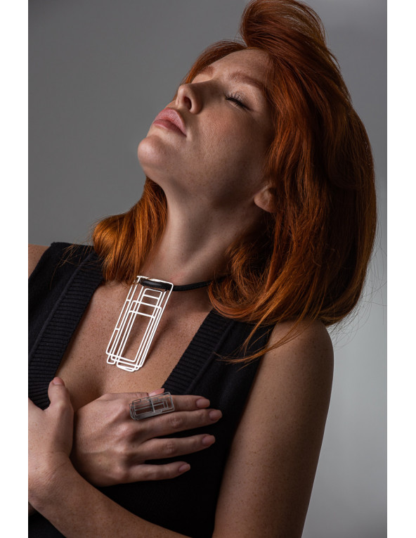 Delicate leather necklace with a shiny stainless steel pendant in a modern design