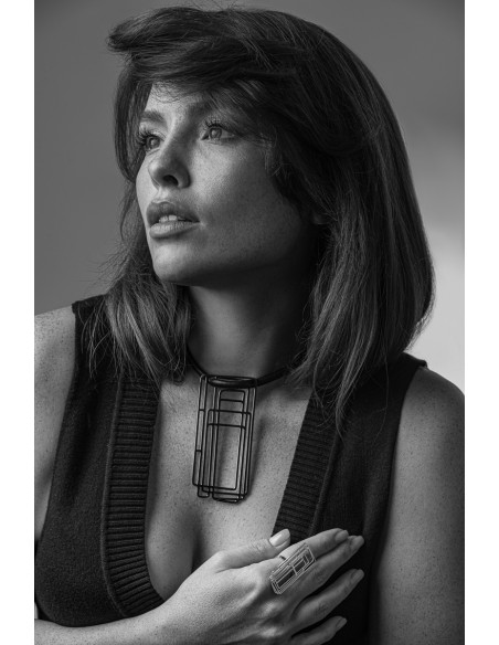 Delicate leather necklace with a shiny stainless steel pendant in a modern design