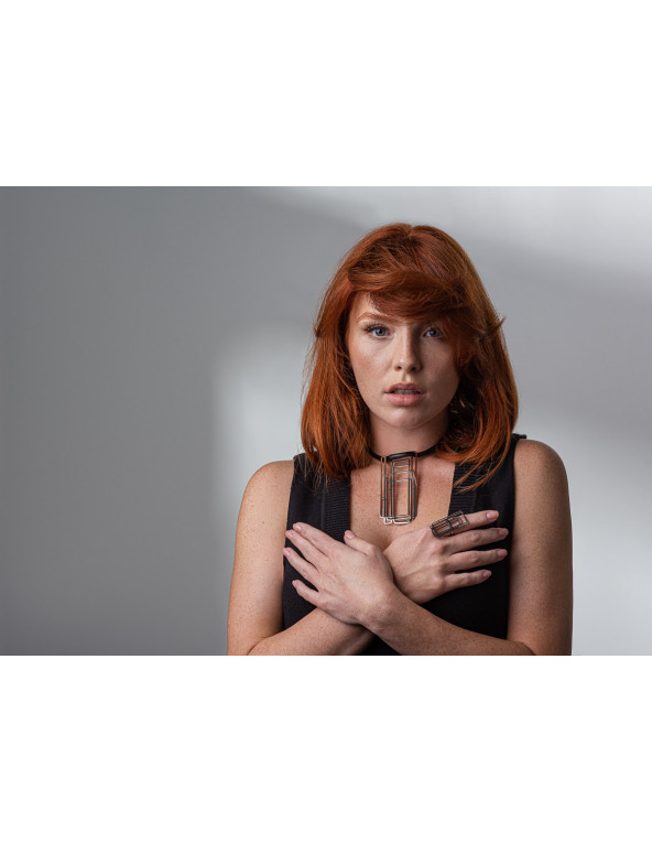 Delicate leather necklace with a shiny stainless steel pendant in a modern design