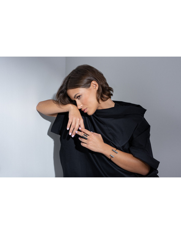 A delicate and raw jewellery set made of black stainless steel