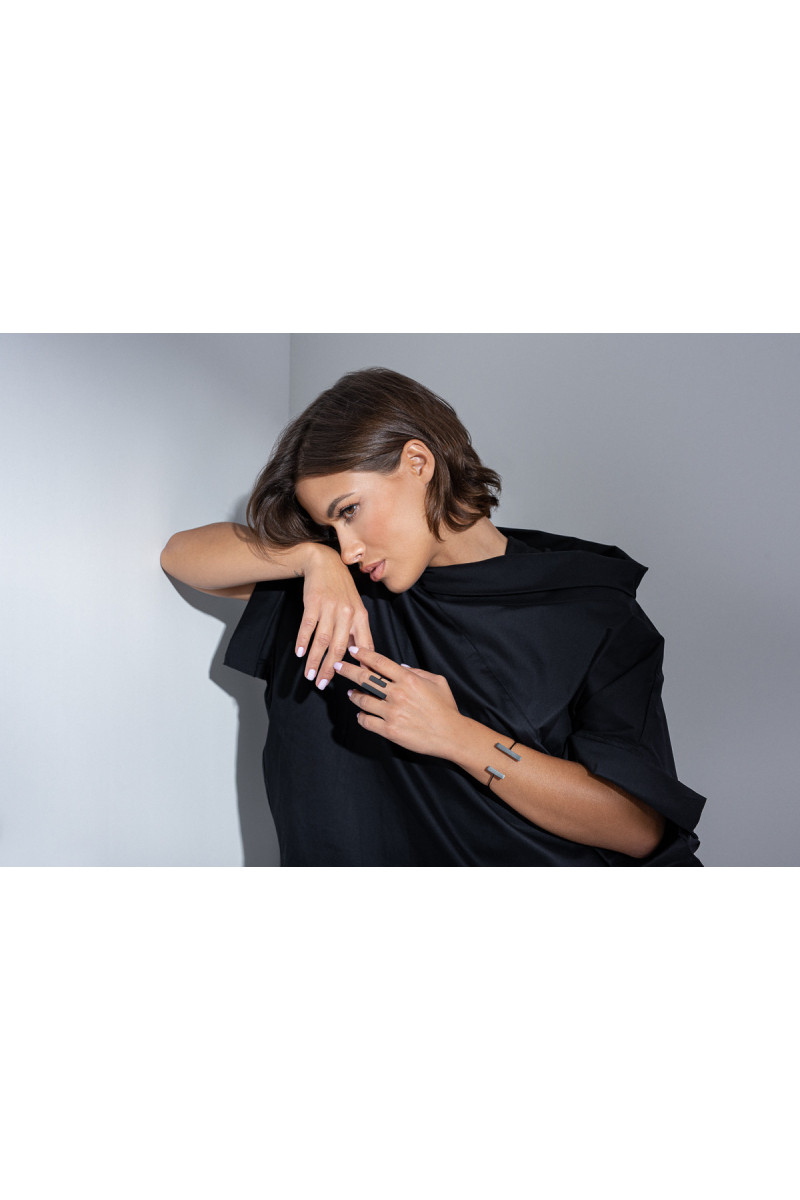 A delicate and raw jewellery set made of black stainless steel
