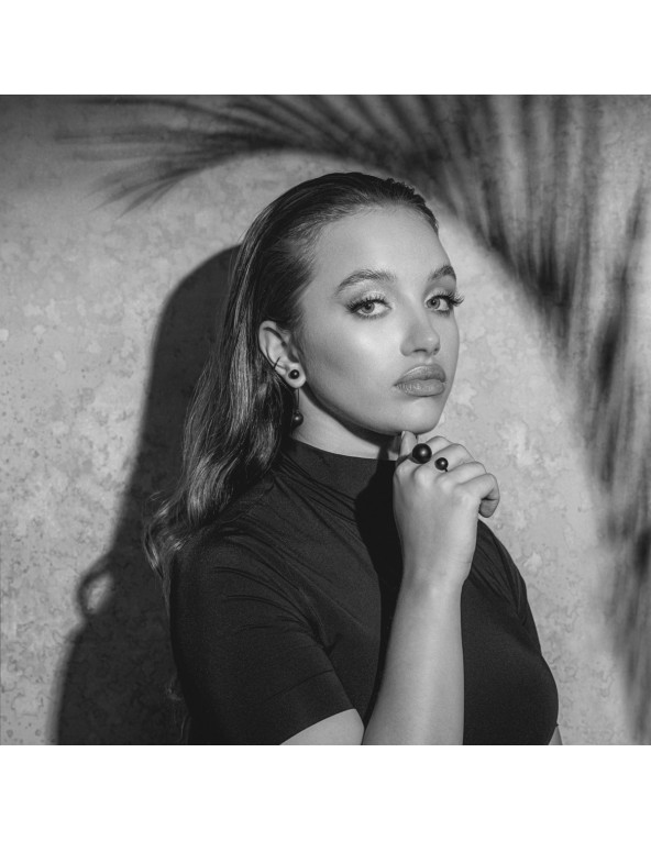 Matte black stainless steel ring with two spheres in minimalist style