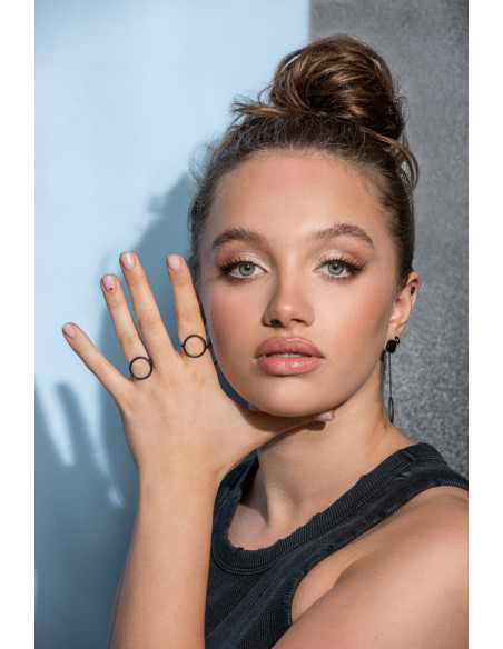 A delicate ring made of matte black stainless steel in a circular form.