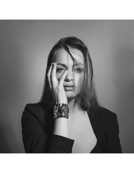 Wide gold bracelet made of crumpled stainless steel with shiny golden finish