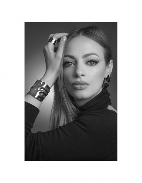 Wide gold bracelet made of crumpled stainless steel with shiny golden finish