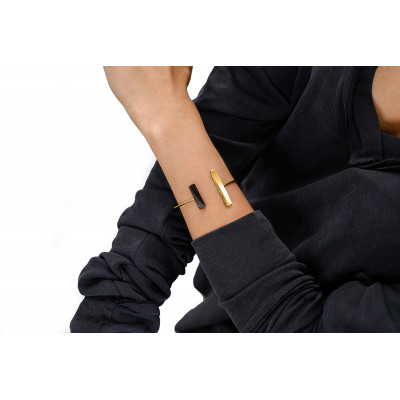 Delicate stainless steel jewelry set in black and gold – ring, bracelet, and earrings in a polished finish 2