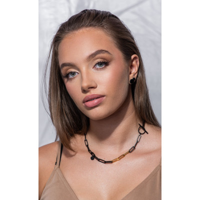 Short black matte stainless steel necklace with large gold-accented links. 2