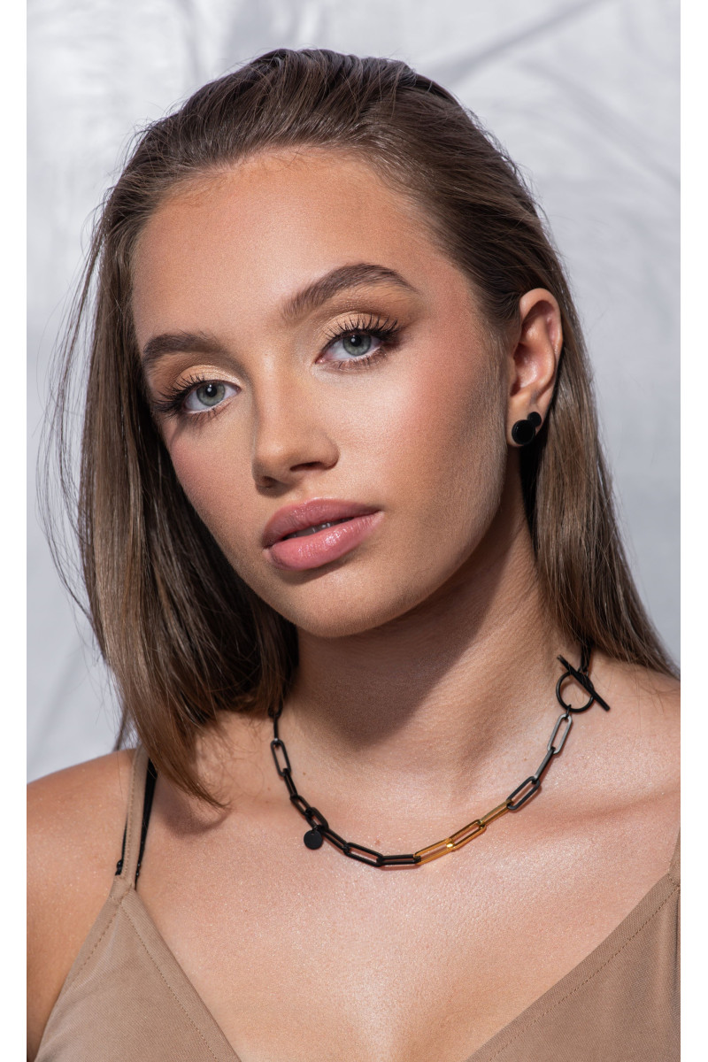 Short black matte stainless steel necklace with large gold-accented links.