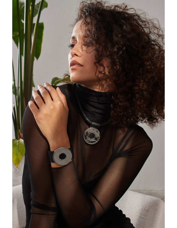Black leather bracelet with matte steel circle in a wide, geometric design