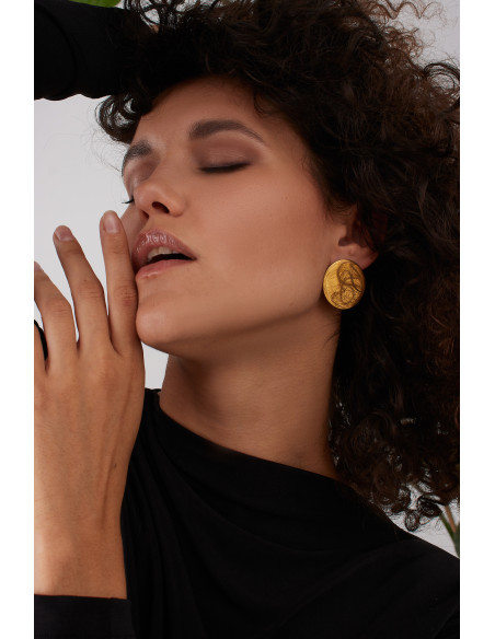 Gold stainless steel disc hoop earrings with a shiny finish and modern minimalist style.