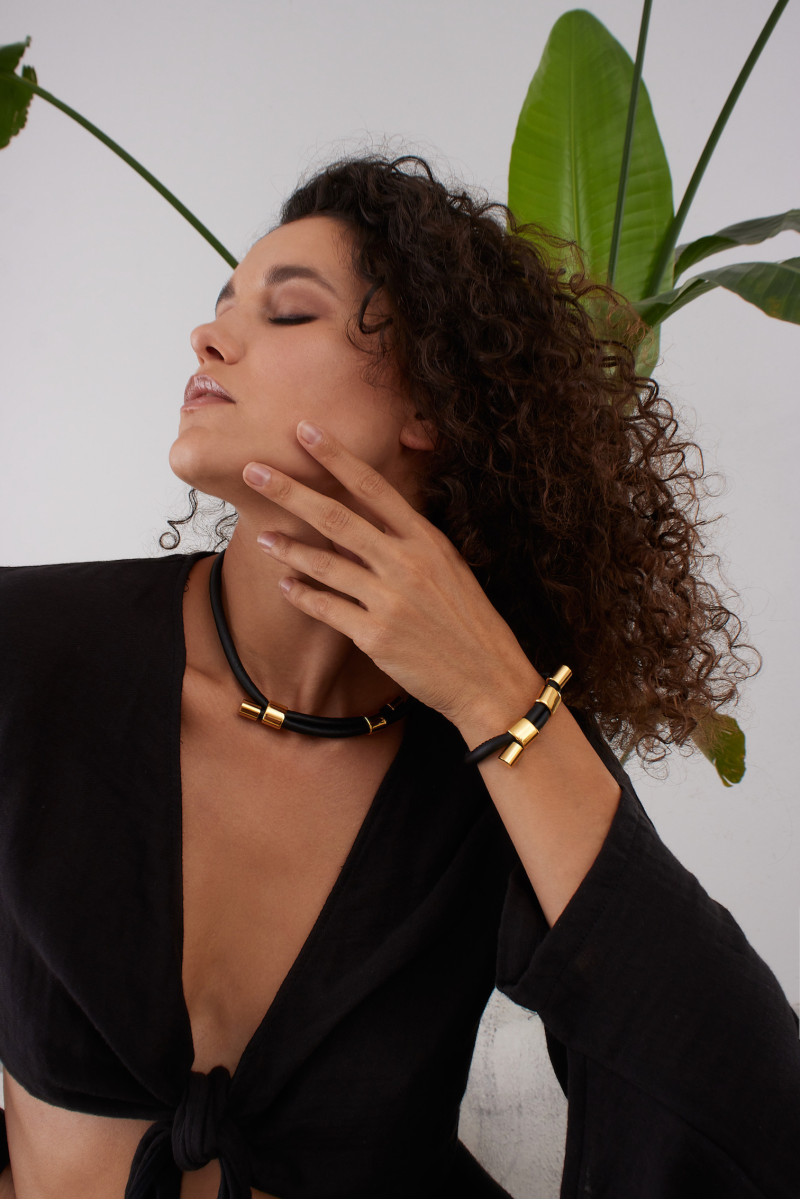 Black leather and gold-plated steel jewelry set with modern design