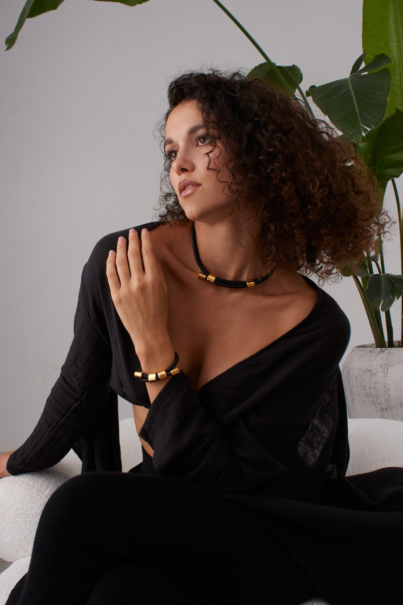 Black leather and gold-plated steel jewelry set with modern design