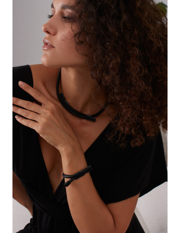 Adjustable necklace and bracelet set made of natural leather and matte black stainless steel.