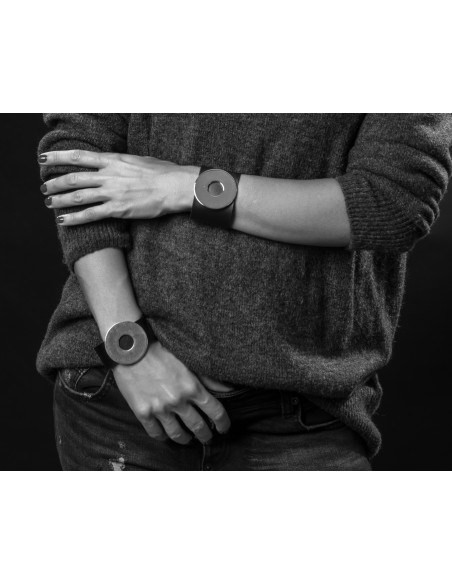 Black leather bracelet with a large, glossy gold-plated stainless steel element