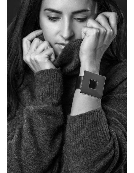 Black women's leather bracelet with a gold-plated square accent and a magnetic gold clasp