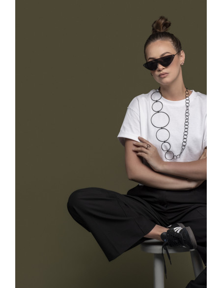 Long matte black stainless steel necklace made of interconnected circles in various sizes.