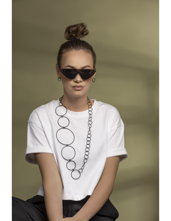 Long matte black stainless steel necklace made of interconnected circles in various sizes.