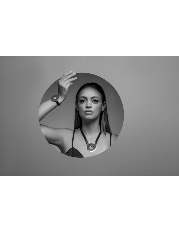 Black leather necklace with large shiny silver stainless steel circle pendant.