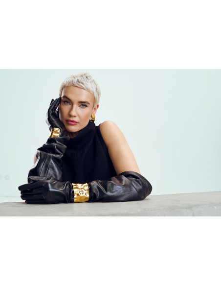 Wide gold bracelet made of crumpled stainless steel with shiny golden finish