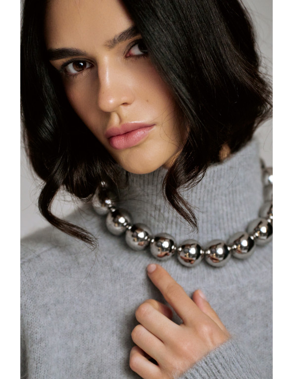 Elegant stainless steel necklace with large polished sphere.