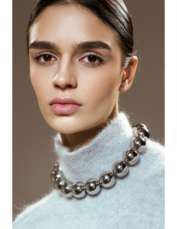 Elegant stainless steel necklace with large polished sphere.