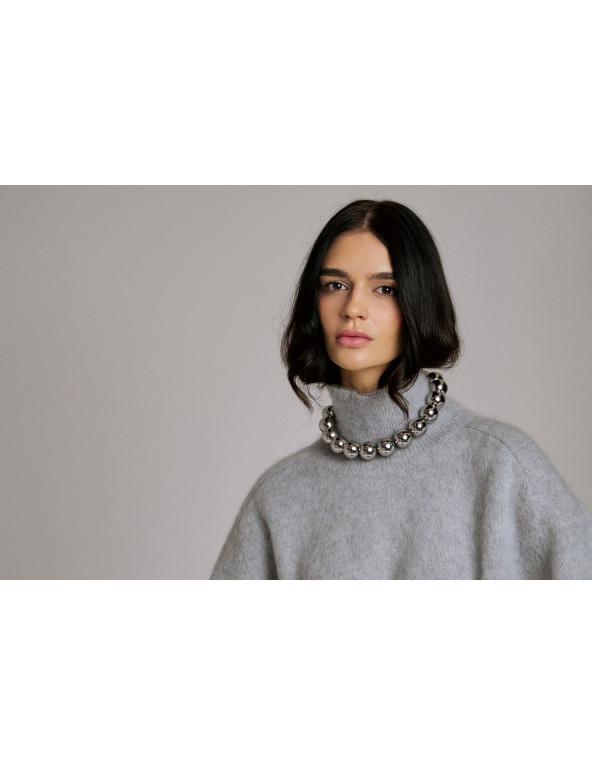 Elegant stainless steel necklace with large polished sphere.