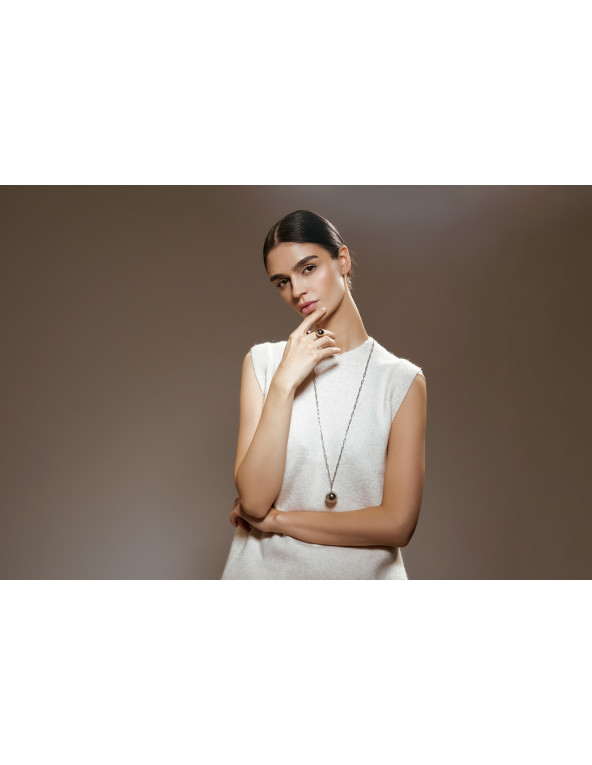 Long silver stainless steel necklace with large decorative sphere.