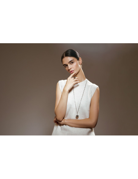 Long silver stainless steel necklace with large decorative sphere.