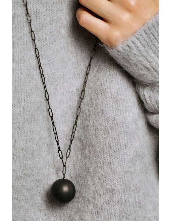 Long necklace in black matte stainless steel featuring a large decorative sphere.