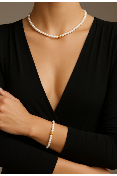 Delicate necklace with white shell pearls on a thin stainless steel chain.