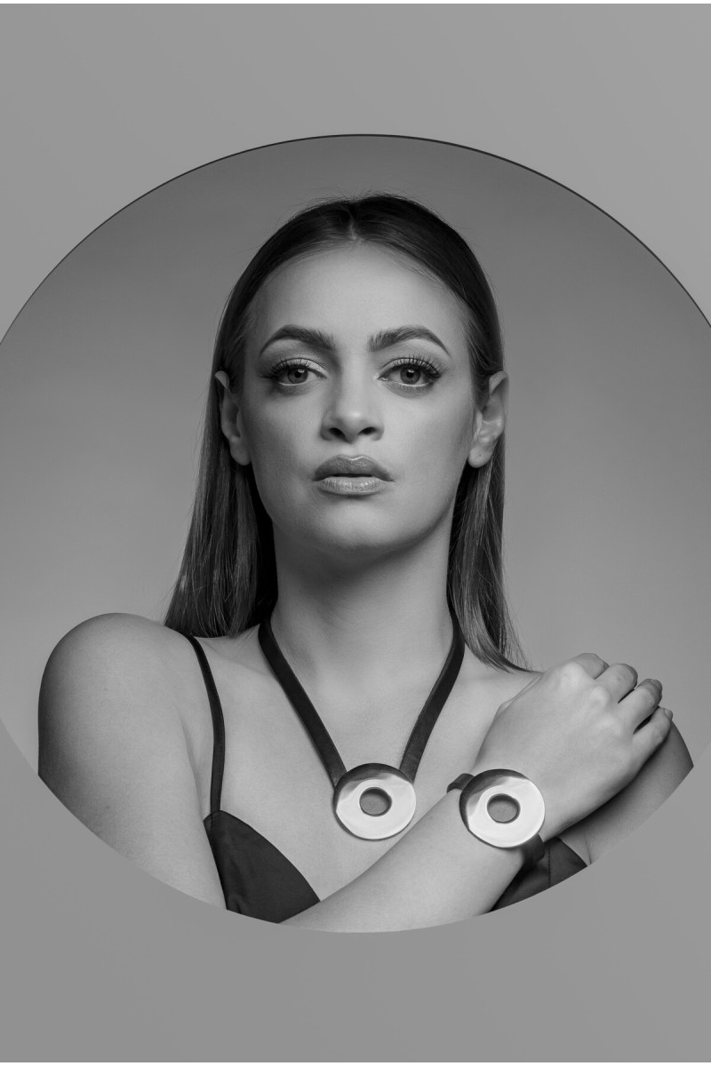 Brown leather necklace with a large polished stainless steel circle