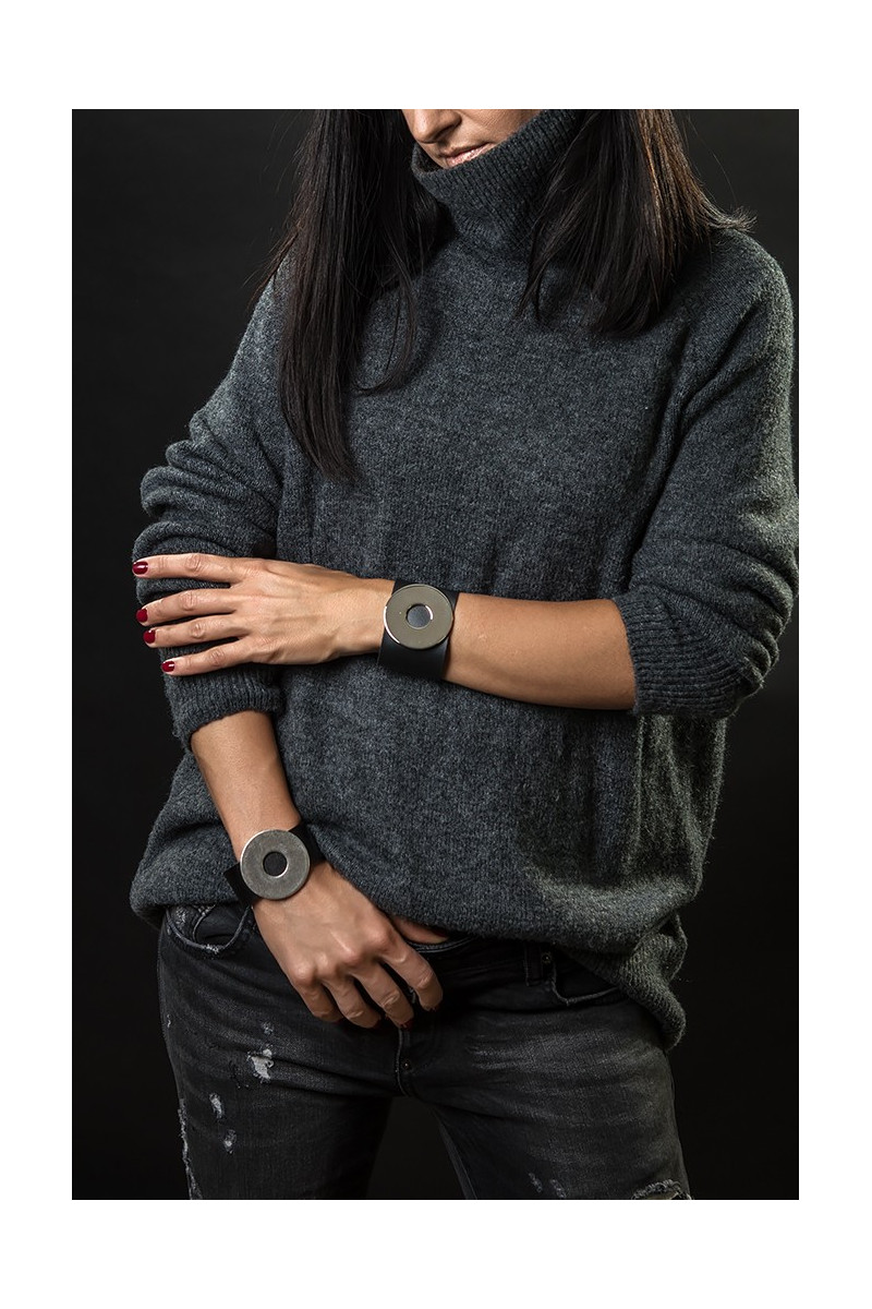 Wide black leather bracelet with matte steel circle and bold minimalist design